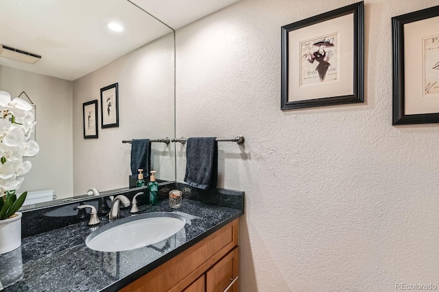 611 E 7th Ave, Denver, CO 80203 - bathroom featuring recessed lighting, vanity, a textured wall, and toilet