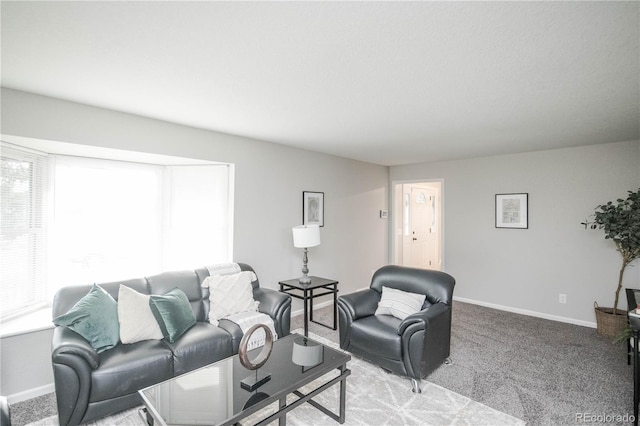 living area featuring light colored carpet and baseboards