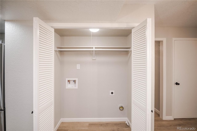 laundry area featuring baseboards, hookup for an electric dryer, wood finished floors, and laundry area