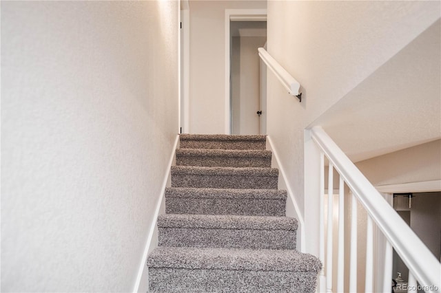 stairs featuring baseboards