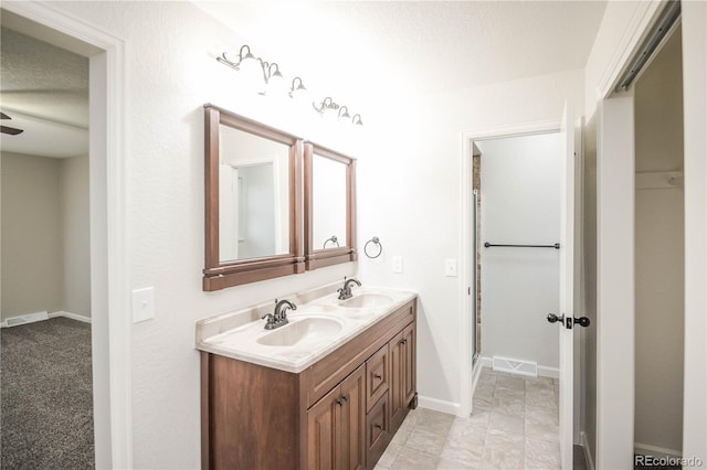 full bath featuring visible vents, a stall shower, and a sink