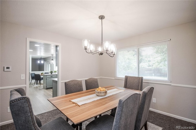 1409 S Moline St, Aurora, CO 80012 - dining room with baseboards and a chandelier