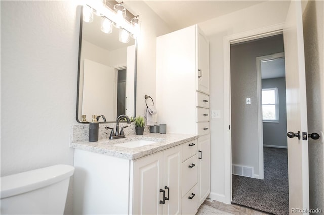 1409 S Moline St, Aurora, CO 80012 - bathroom featuring toilet, vanity, and baseboards