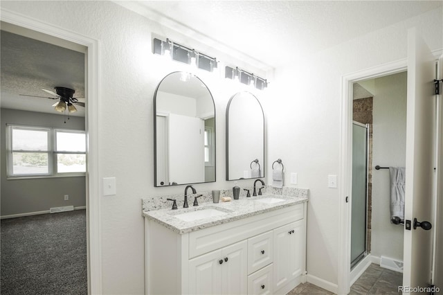 1409 S Moline St, Aurora, CO 80012 - full bathroom with baseboards, double vanity, ceiling fan, a shower stall, and a textured ceiling