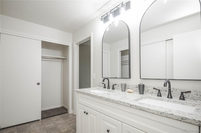 1409 S Moline St, Aurora, CO 80012 - bathroom featuring double vanity and stone finish flooring