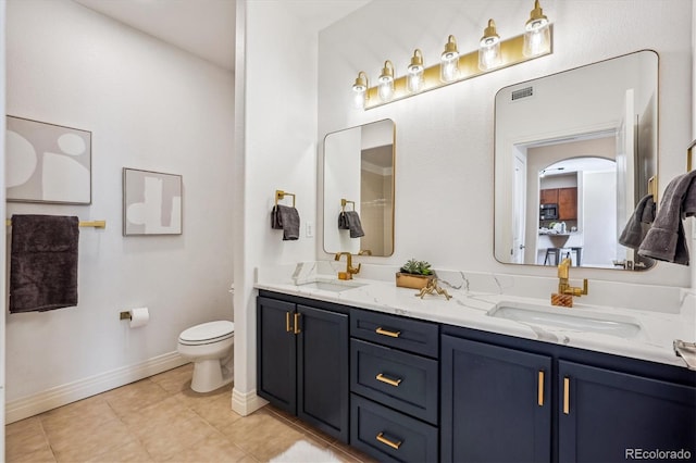 bathroom featuring tile patterned flooring, vanity, and toilet