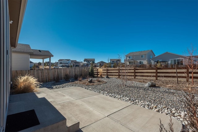 view of patio / terrace with a fenced backyard and a residential view