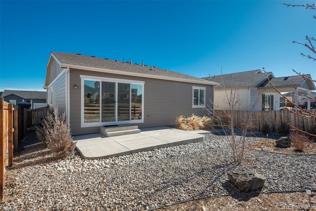 rear view of property with fence private yard and a patio