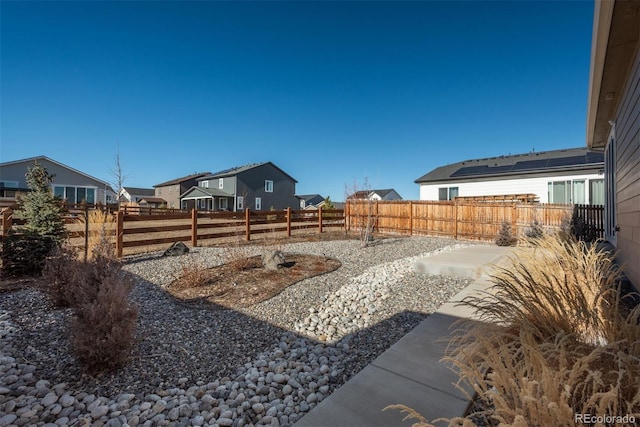 view of yard with a fenced backyard and a residential view