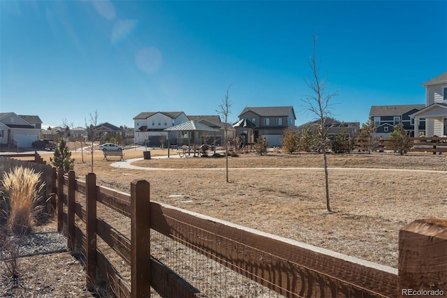 view of yard featuring a residential view, fence, and a gazebo