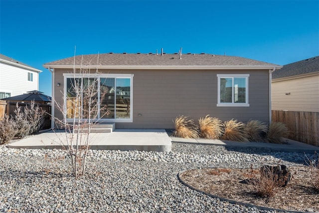 rear view of property featuring a patio area and fence