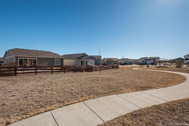 view of yard with a residential view and fence