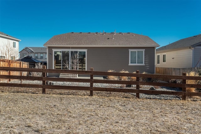 rear view of property with fence