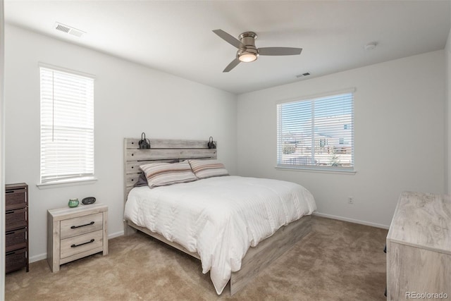 bedroom featuring visible vents, ceiling fan, light carpet, and baseboards