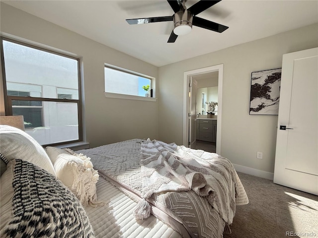 bedroom featuring connected bathroom, ceiling fan, and dark colored carpet