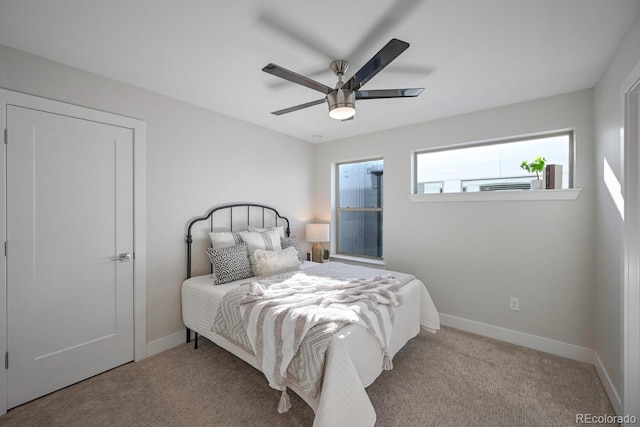 bedroom featuring light carpet and ceiling fan