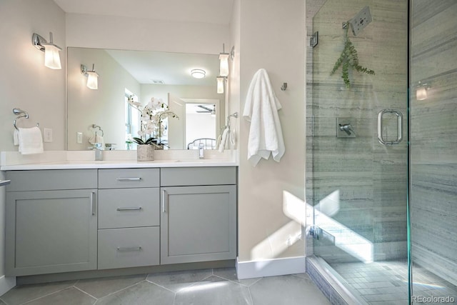 bathroom featuring vanity, a shower with shower door, and tile patterned floors