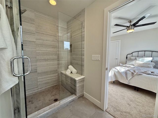 bathroom with a shower with door and ceiling fan