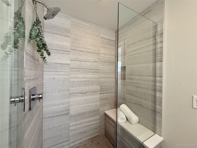 bathroom with a tile shower