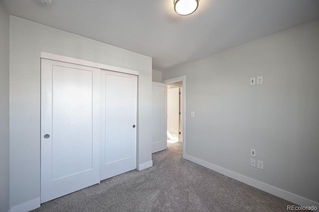 unfurnished bedroom with a closet and carpet