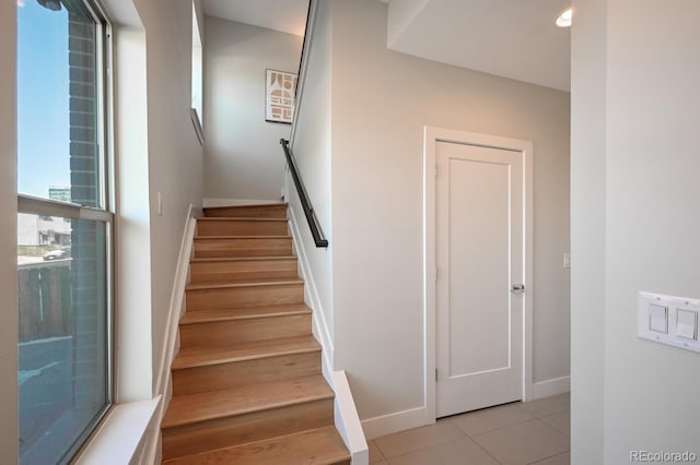 stairs featuring tile patterned flooring