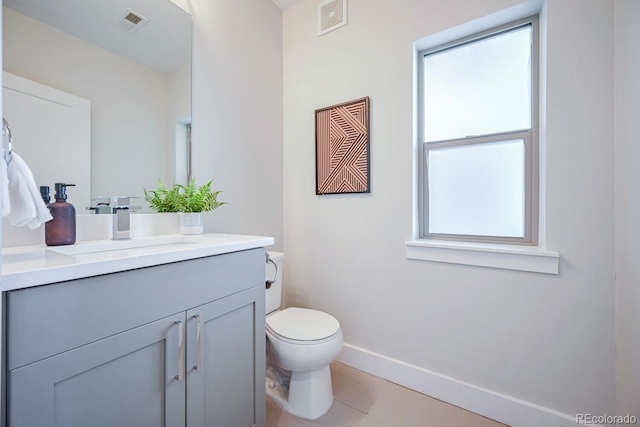 bathroom featuring vanity, tile patterned floors, and toilet