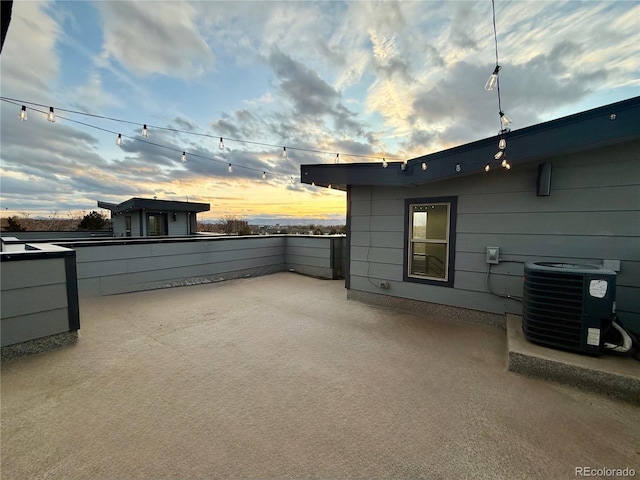 patio terrace at dusk with central air condition unit