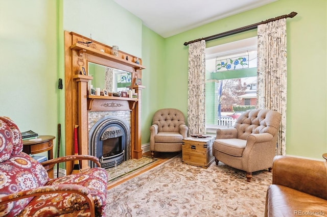 sitting room with plenty of natural light and a fireplace with flush hearth