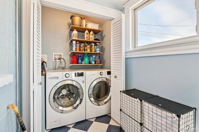 laundry area featuring washing machine and clothes dryer, laundry area, and tile patterned floors