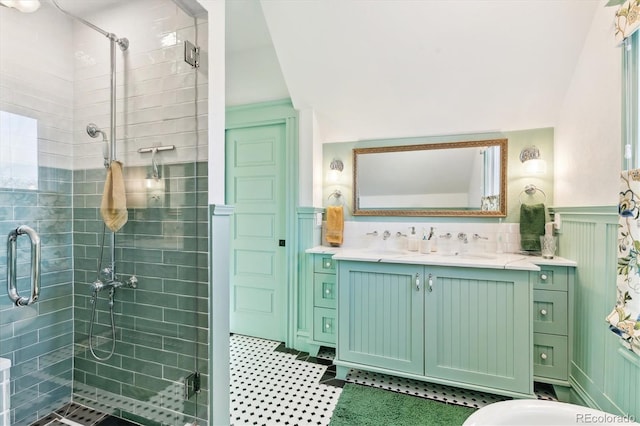 bathroom with vanity, a shower stall, and wainscoting