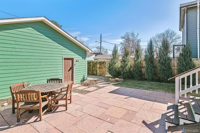 view of patio with outdoor dining space and fence