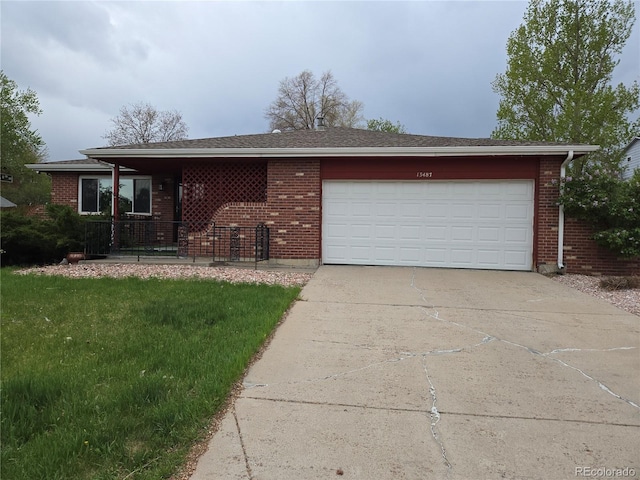 13487 Antares Dr, Littleton, CO 80124 - ranch-style home with concrete driveway, a garage, brick siding, and a front yard