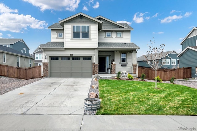 craftsman inspired home with a garage, a front lawn, and covered porch