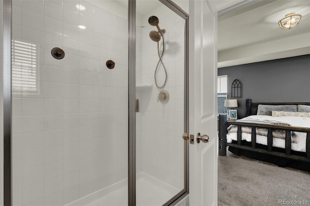 bathroom with a shower with door