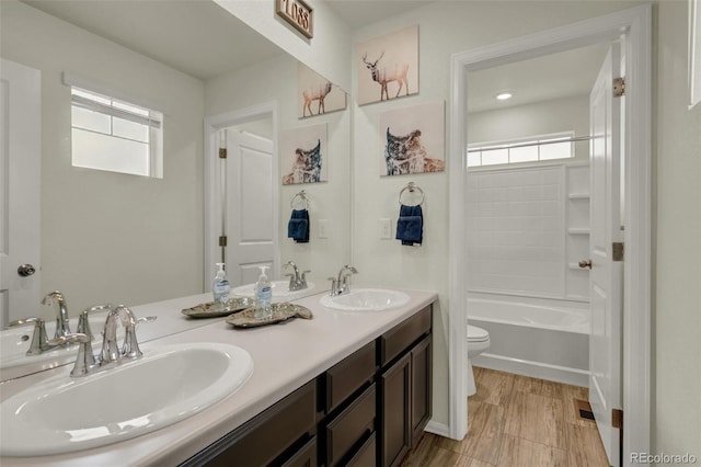 full bathroom featuring vanity, tub / shower combination, and toilet