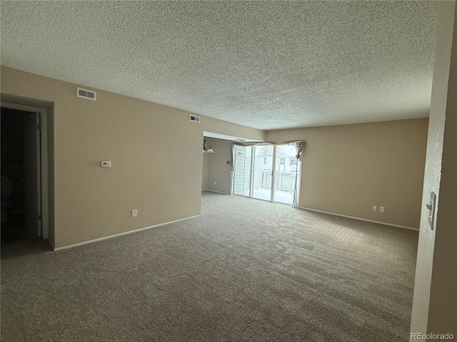 spare room with carpet floors and a textured ceiling