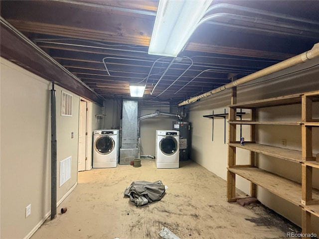 basement with washer and clothes dryer and water heater