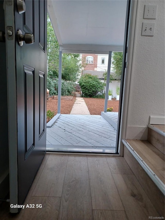 entryway featuring a textured wall and wood finished floors