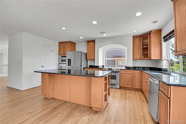 5131 Netherland St, Denver, CO 80249 - kitchen featuring stainless steel appliances, light wood finished floors, dark countertops, a kitchen island, and open shelves