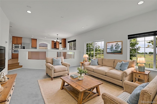 5131 Netherland St, Denver, CO 80249 - living area featuring light colored carpet, recessed lighting, a chandelier, and stairs