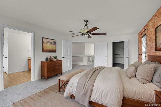 5131 Netherland St, Denver, CO 80249 - bedroom featuring a walk in closet, ensuite bath, ceiling fan, and light carpet