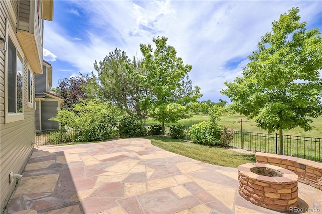 5131 Netherland St, Denver, CO 80249 - fenced backyard with an outdoor fire pit and a patio