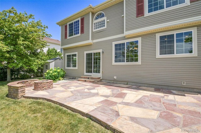 5131 Netherland St, Denver, CO 80249 - rear view of property with a fire pit, a patio area, and entry steps