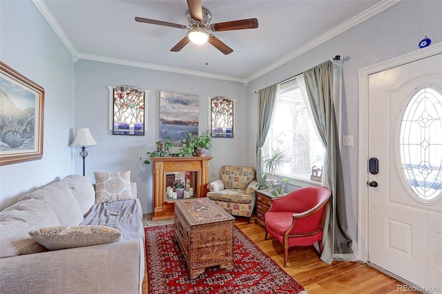 1434 Osceola St, Denver, CO 80204 - living room featuring light wood-style flooring, healthy amount of natural light, a ceiling fan, crown molding, and baseboards