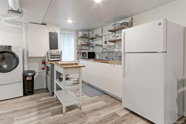 1434 Osceola St, Denver, CO 80204 - kitchen featuring freestanding refrigerator, a sink, white cabinetry, open shelves, and stainless steel microwave