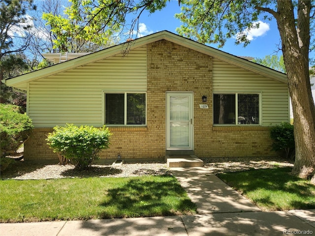 9105 E Lehigh Ave Unit 105, Denver, CO 80237 - bungalow-style home with brick siding and a front yard