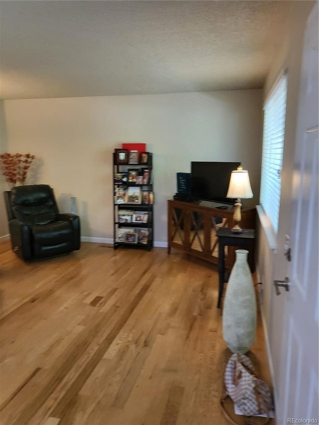 9105 E Lehigh Ave Unit 105, Denver, CO 80237 - sitting room featuring light wood finished floors and baseboards