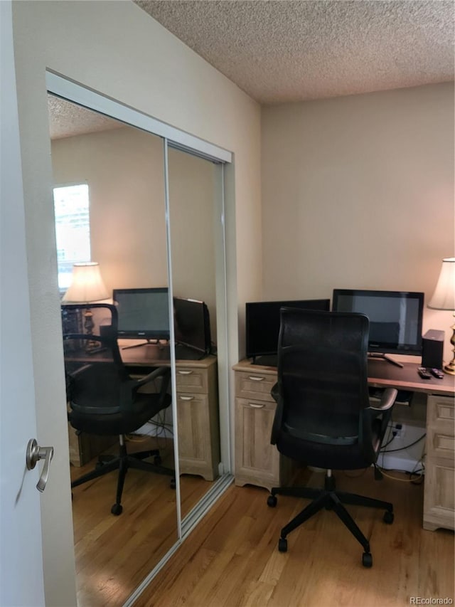 9105 E Lehigh Ave Unit 105, Denver, CO 80237 - home office with light wood finished floors and a textured ceiling