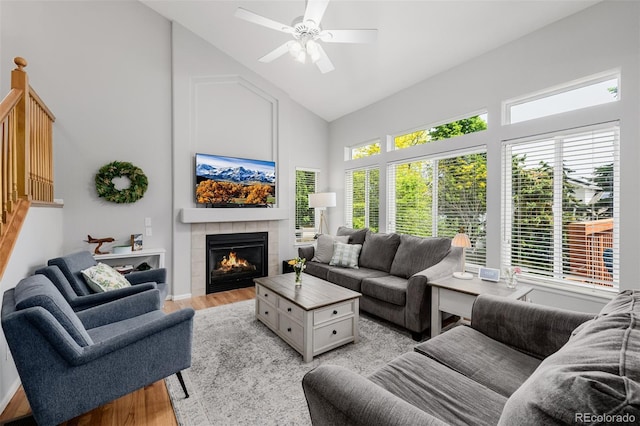 527 English Sparrow Trl, Highlands Ranch, CO 80129 - living area featuring high vaulted ceiling, light wood-style flooring, a fireplace, and ceiling fan