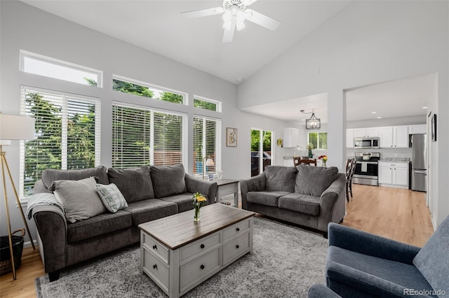 527 English Sparrow Trl, Highlands Ranch, CO 80129 - living room with light wood-type flooring, ceiling fan, and high vaulted ceiling